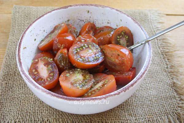 Перемешать томаты с маслом и травами