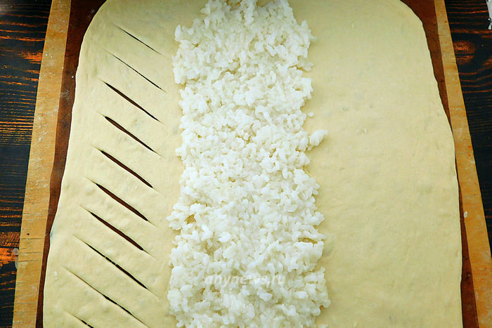 На раскатанное тесто выложить рис