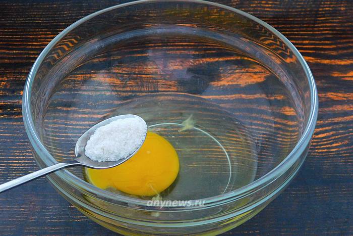 В миску разбить куриное яйцо, всыпать соль