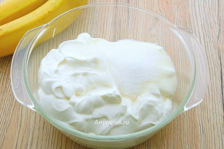 В просторную миску выложить сметану и сахар
